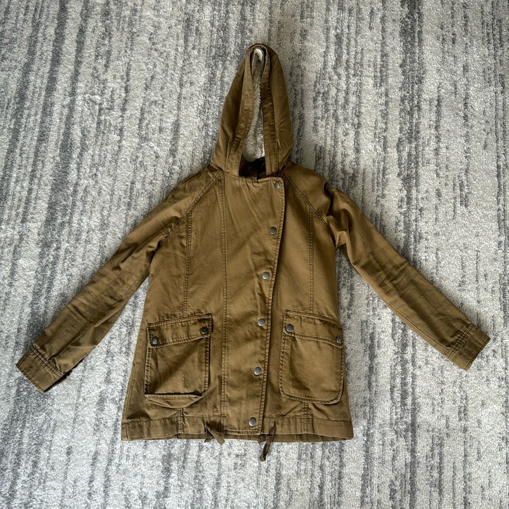 Green jacket with fuzzy lining in body section and hood